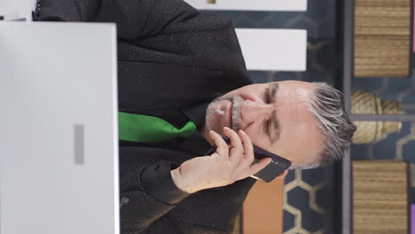 Vertical-video-of-Aggressive-businessman-talking-on-the-phone-angrily.